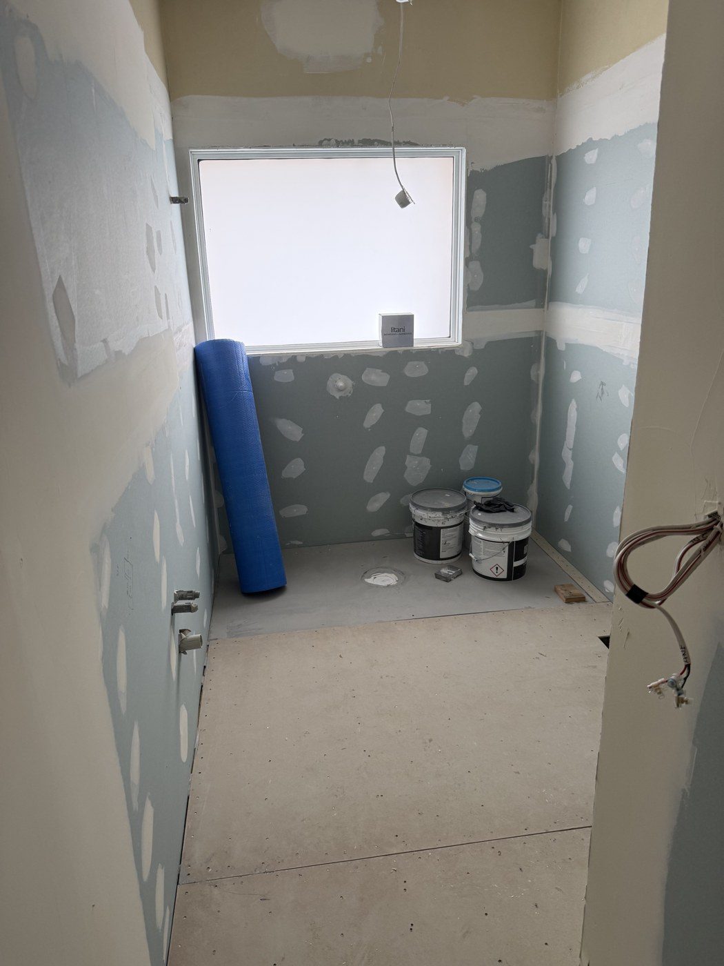 New wall sheeting and floor prepared for waterproofing in the Altona North bathroom