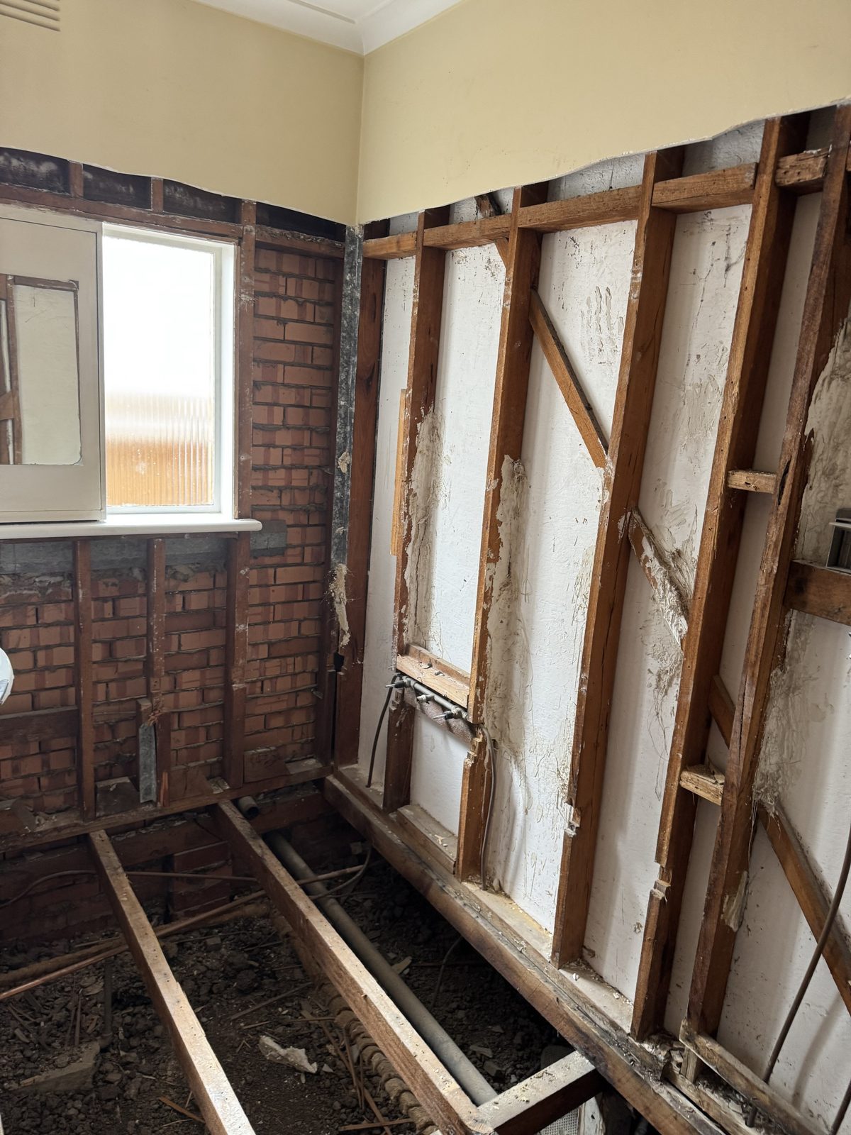 Bathroom stripped to the original timber frame and brick, Altona North