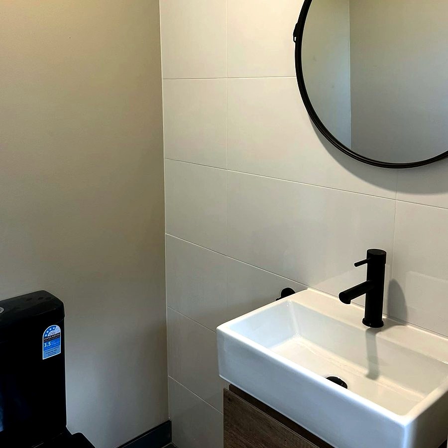 Bathroom renovation with dark feature tile