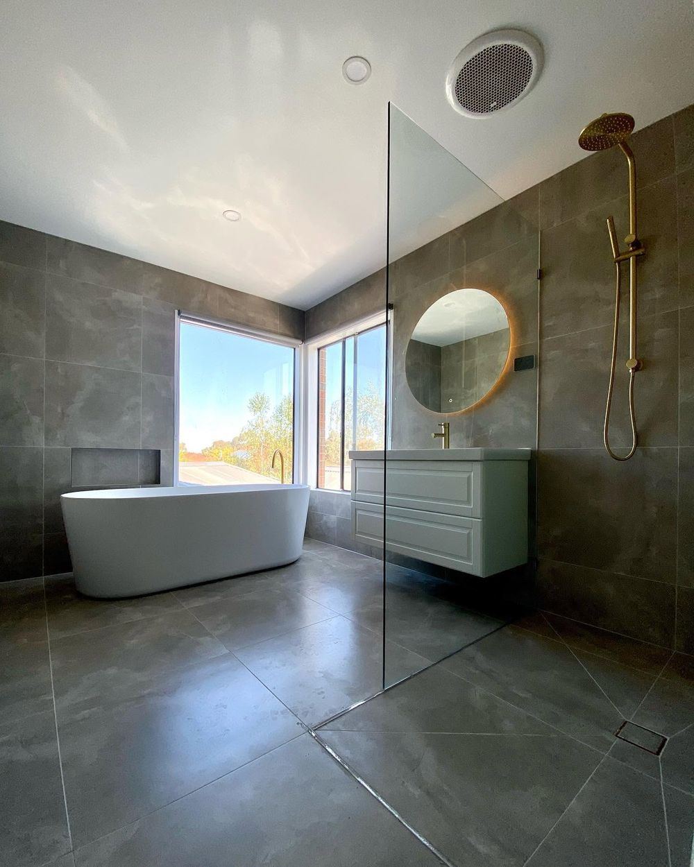 Renovated bathroom with freestanding bath and brass tapware