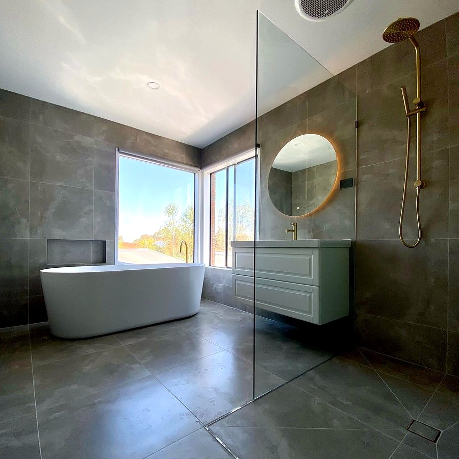 Bathroom renovation with freestanding bath and skylight