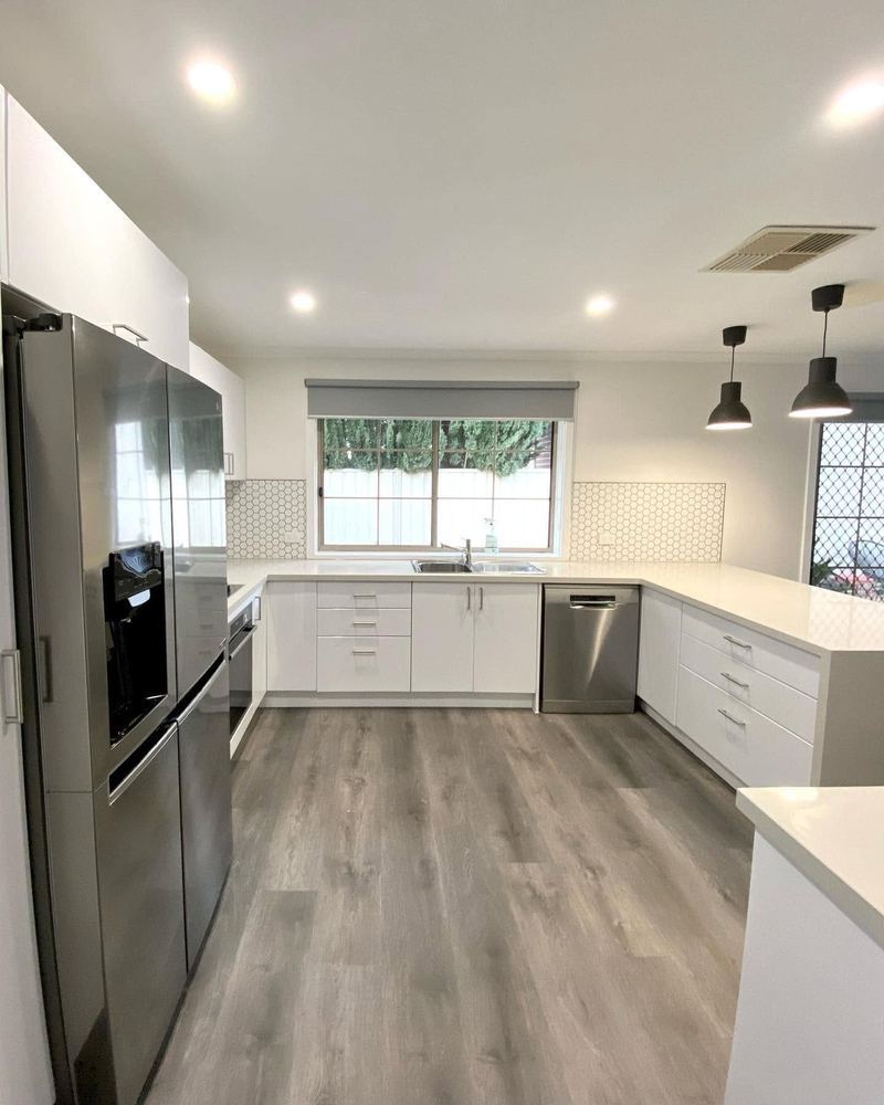 Kitchen renovation with pendant lighting and window over the sink