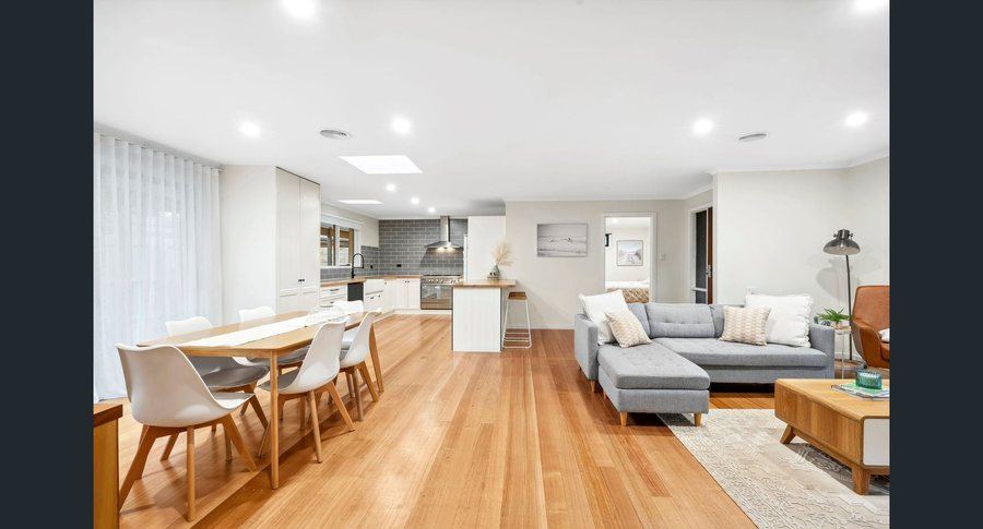 Open plan kitchen and living area with timber flooring